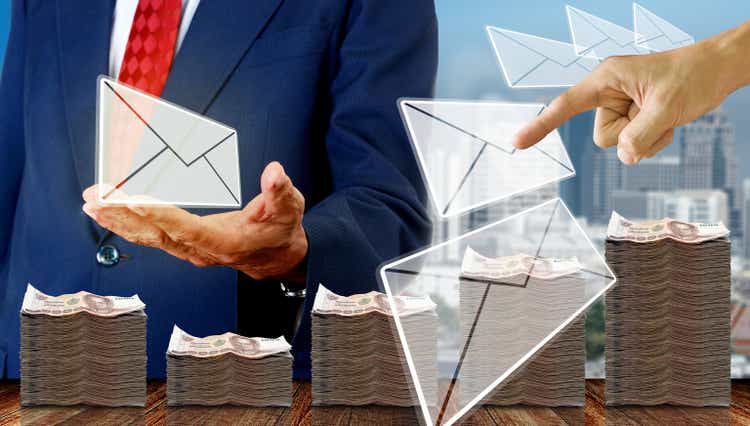 Finger pointing on e-mail with businessman got e-mail background