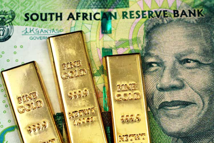 A South African ten rand bank note with three small gold bars