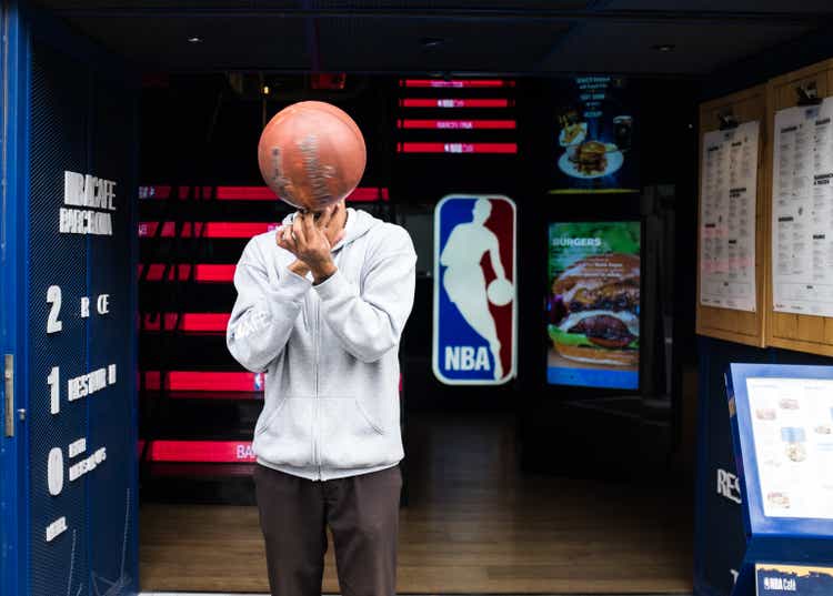 NBA Café Barcelona in Barcelona. Fit man spinning a basketball.