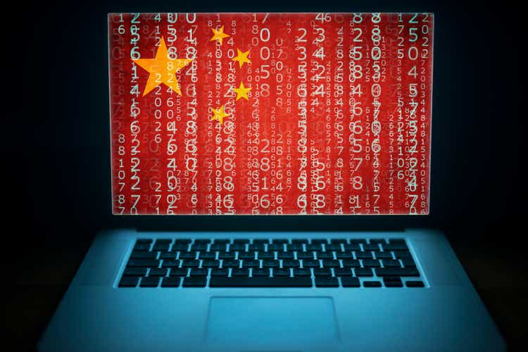 Chinese national internet security. Chinese hacker. Laptop with binary computer code and china flag on the screen.