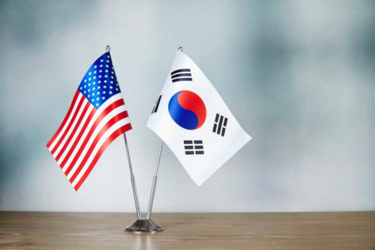 American and South Korean flag standing on the table