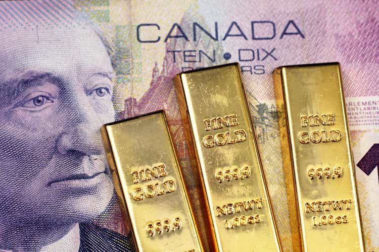 Canadian $10 bill with three gold bars