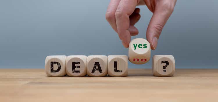 Deal or no deal? Hand turns a cube and changes the word "no" to "yes".