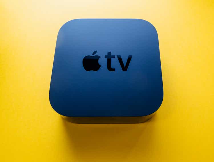 New Apple TV 4k console device against yellow background
