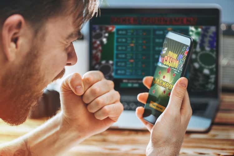 Man celebrating victory after making bets at bookmaker website