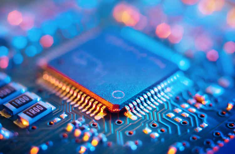 Computer Microchips and Processors on Electronic circuit board. Abstract technology microelectronics concept background. Macro shot, shallow focus.