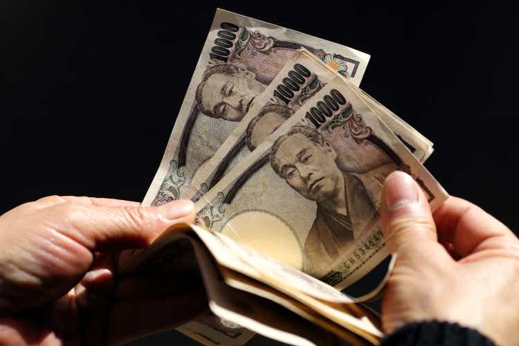 Counting JPY(Japanese Yen) 10,000 banknotes