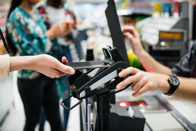 Close Up Of Contactless Payment With Smartphone