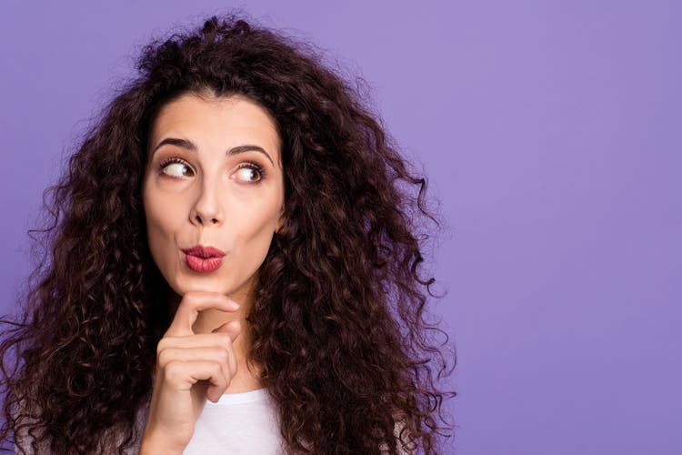 Close up photo funky beautiful her she lady hold arm hand chin look side empty space think over oops I did it again face wear casual white t-shirt clothes outfit isolated violet purple background