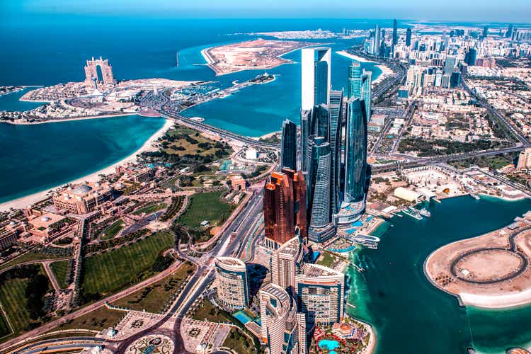 Beautiful high angle view of the modern skyscrapers of Abu Dhabi taken from a helicopter.You can also see the pier behind