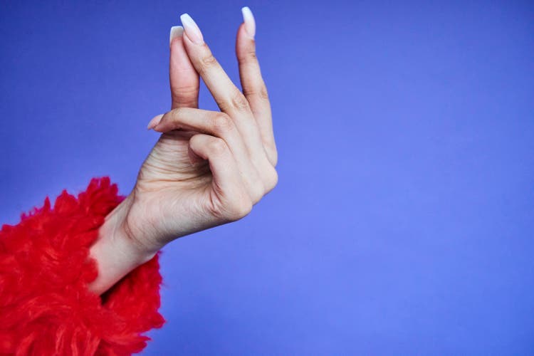 Colourful studio portrait of a young woman"s hand