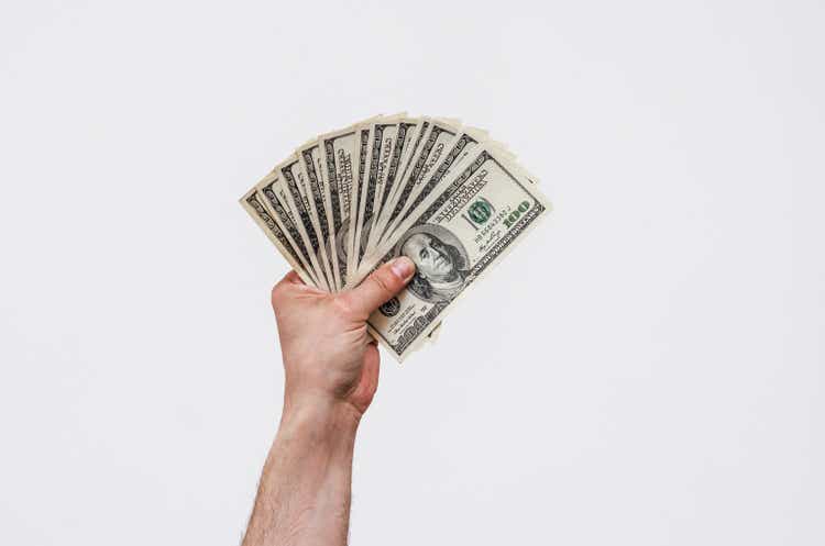 Man"s hand holds american dollars money. Finance, earnings, crediting