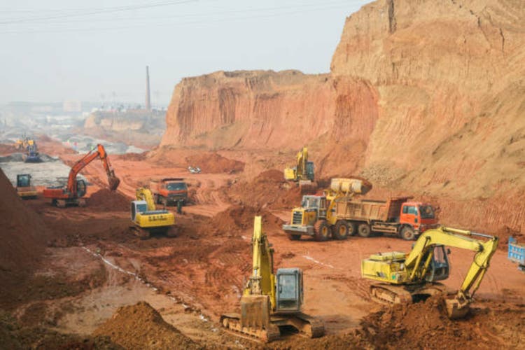 Jiangxi, China: January 2, 2010: Workers on the road construction site of Lianxi Avenue are busy operating large engineering vehicles. China has made great progress in infrastructure construction.