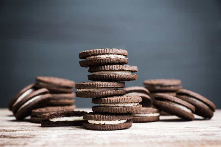 Stack of chocolate sandwich cookies on the rustic wooden background