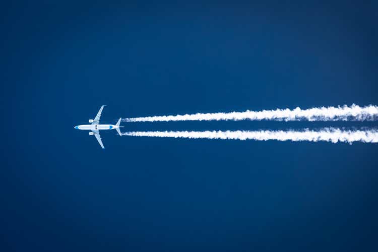 Boeing 737 Enter Air flying by. Air to Air photo of Contrails
