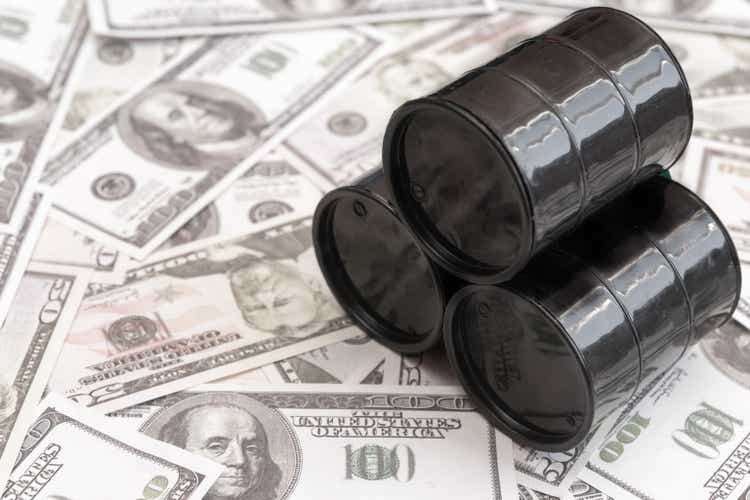 Barrels of oil against the background of American dollars
