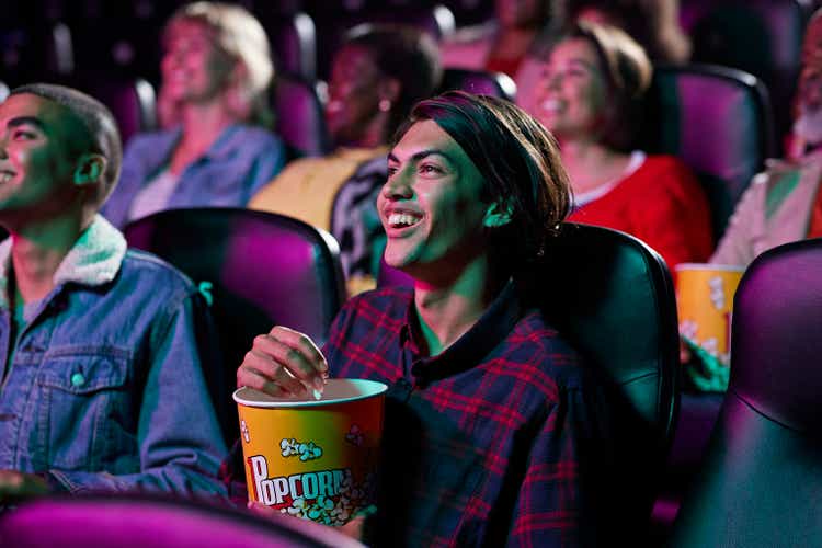 Happy audience watching movie in cinema hall