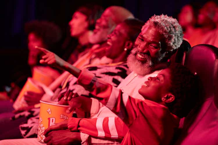 Happy father with excited daughter in theater