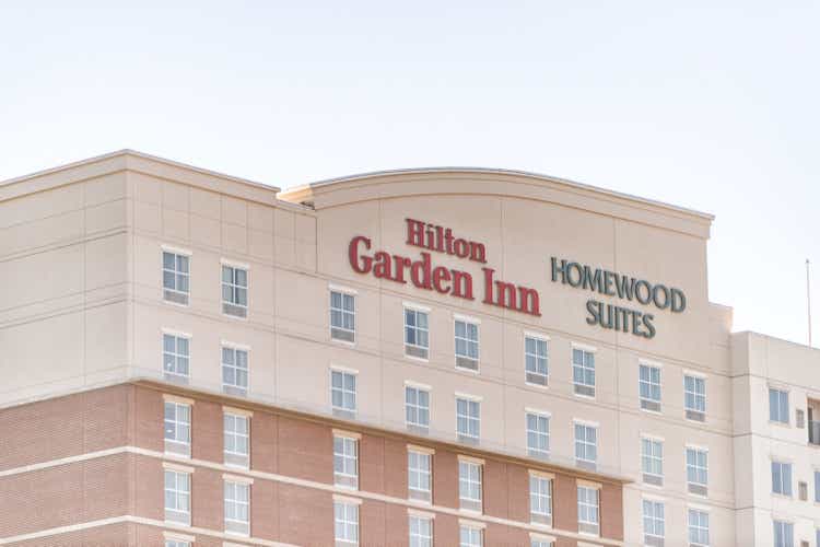 Hilton Garden Inn sign on building in Georgia city, Homewood suites, closeup and sky