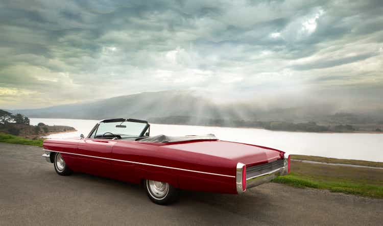 Red convertible parked on side of road