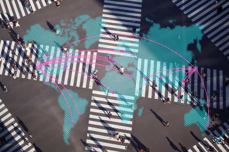 Multi layered, people walking on a pedestrian crossing with world map