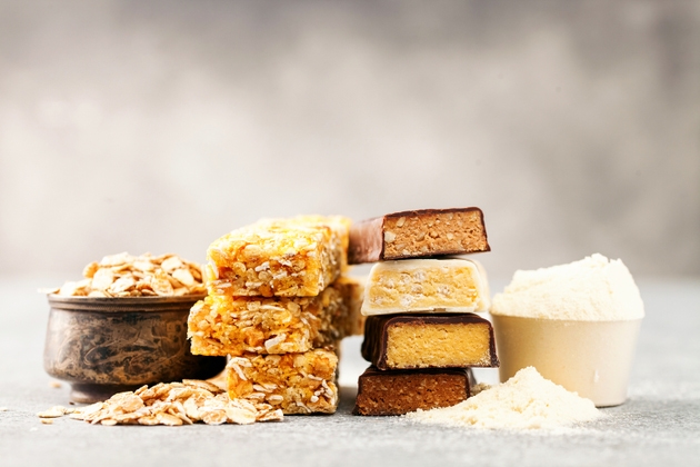 Different Energy protein bars and oatmeal bars on grey background. Set of energy, sport, breakfast and protein bars