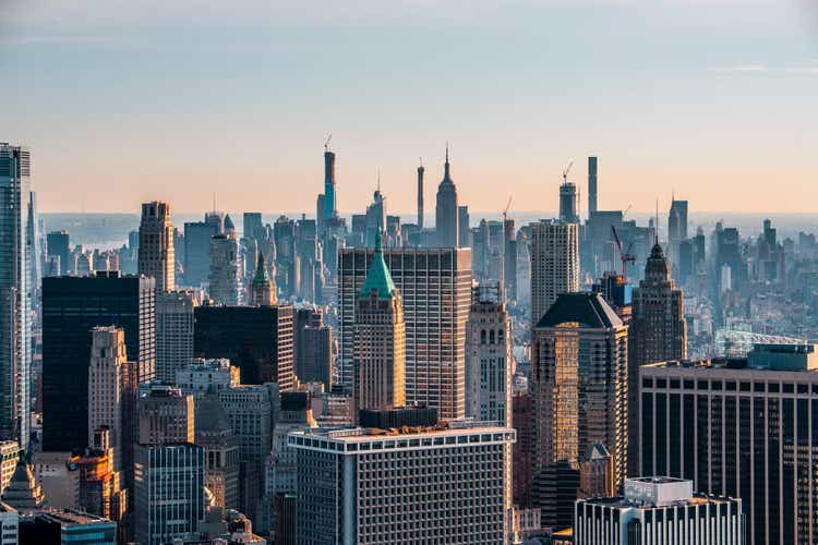 New York City skyline with the Trump Tower in Lower Manhattan, taken from a helicopter flying above rooftops at sunrise