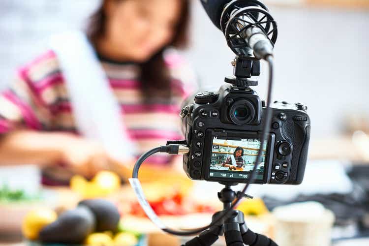 Video camera filming woman preparing food