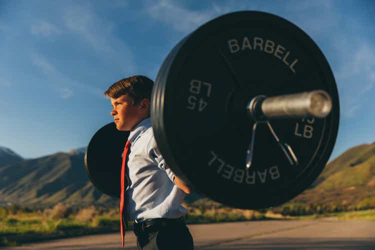 Young Boy Businessman with Weights
