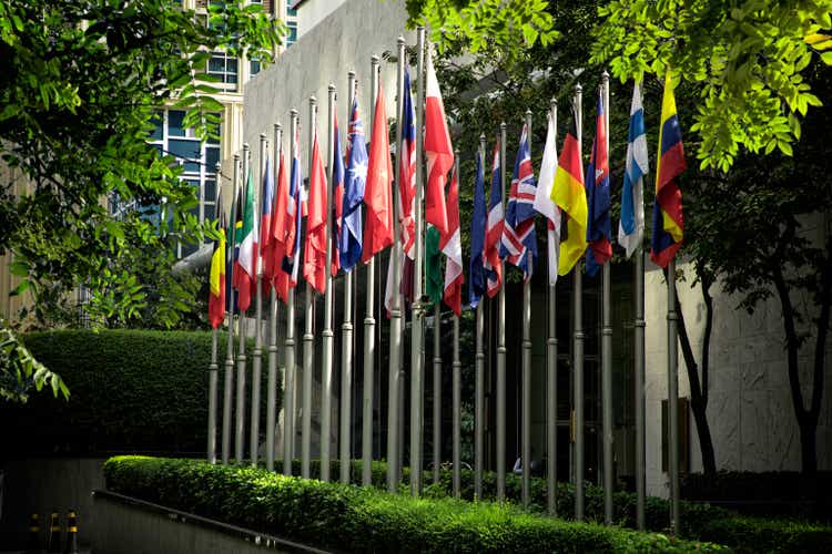 Close up group of colorful various countries flags at flagpoles