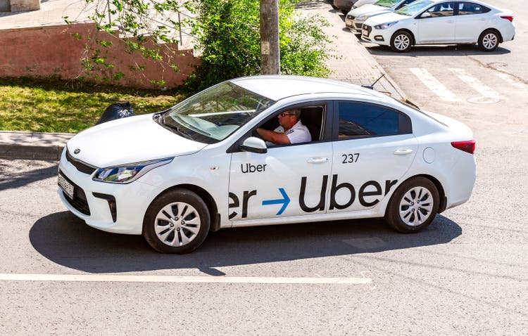 Uber taxi goes down the street
