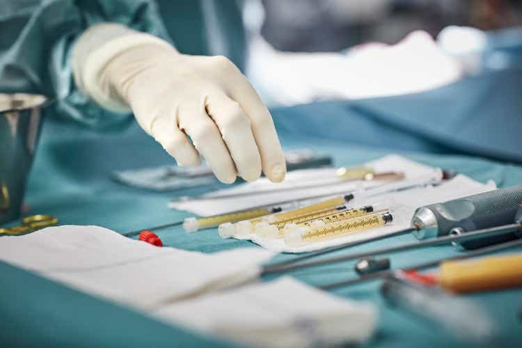 Close-up of female surgeon"s hand over equipment