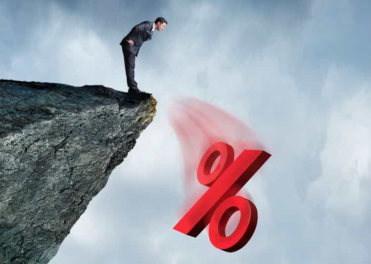 Businessman Watching Interest Rates Fall Off A Cliff