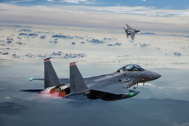 F-15 Eagle Fighter Jets im Flug mit Nachbrenner über den nebeligen Bergen