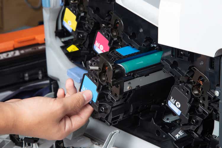 Business man or technician is checking and changing the printer equipment cartridges tone of laser jet multi function printer in the office.