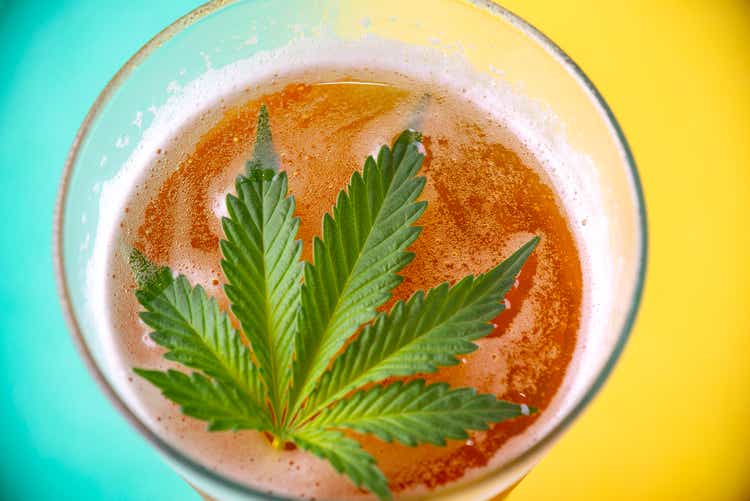 Detail of cold glass of beer with cannabis leaf