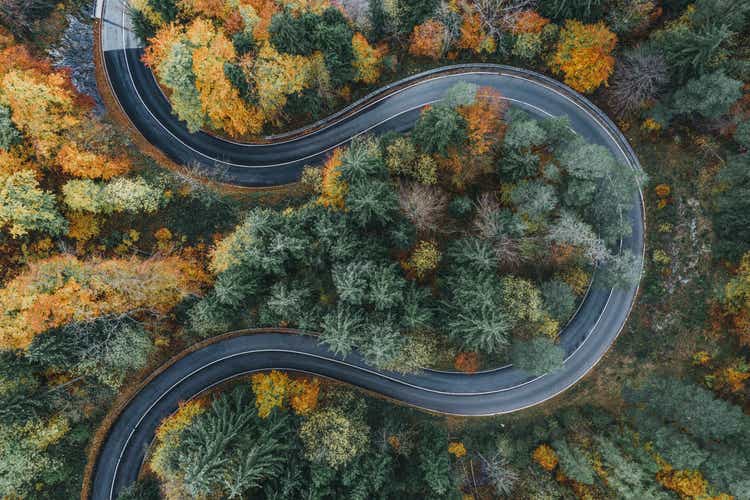 Curved road during autumn in the Bavarian alps as seen from above, Germany