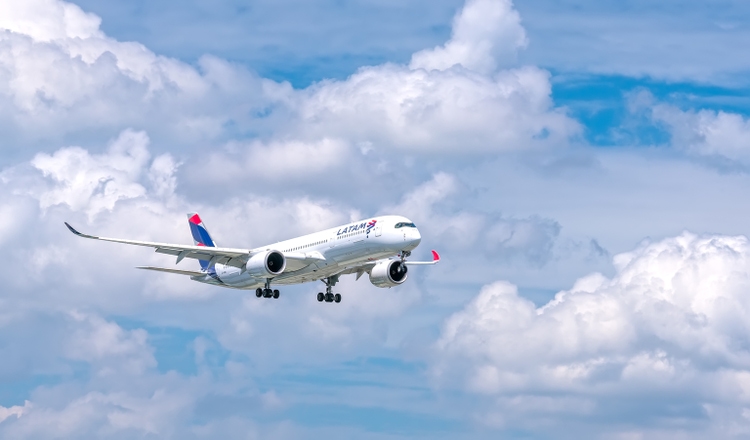 Passenger airplane Airbus A350 of LATAM Airlines flying over urban prepare to landing