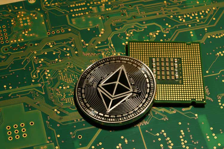 close-up of ethereum ETH cryptocurrency with cpu chip on printed electronic circuit.