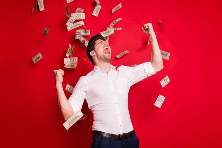 Photo of businessman promoted at work celebrating his victory financial independence while isolated with red background