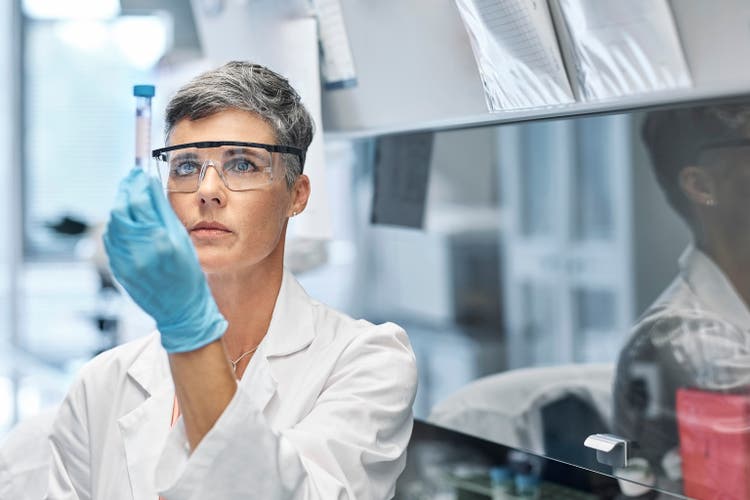 Female researcher examining medical sample in lab