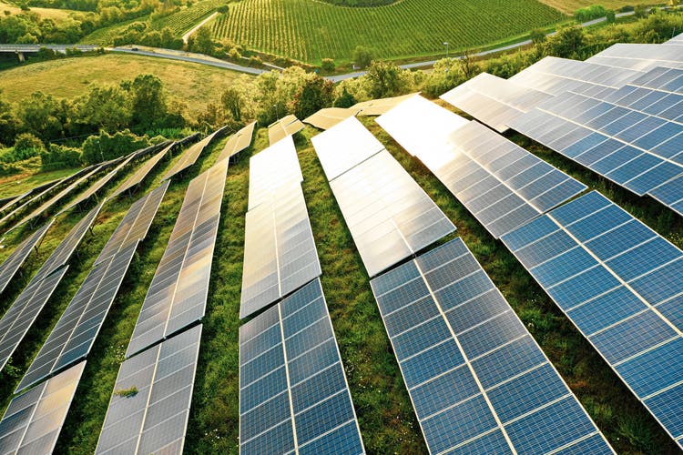 Solar panel field on green hills