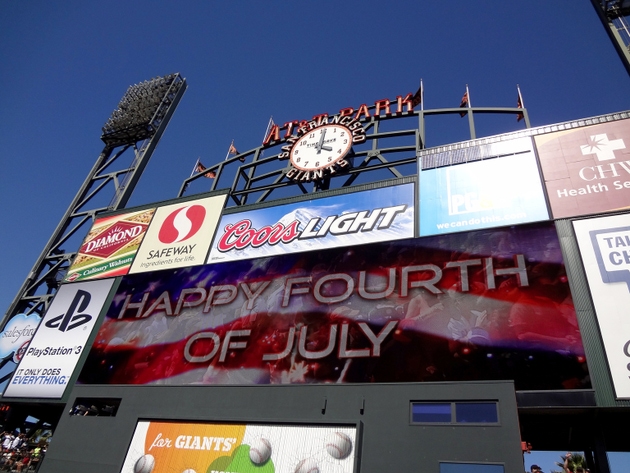 "Happy Fourth of July" Sign with flag on Scoreboard in between innings of game