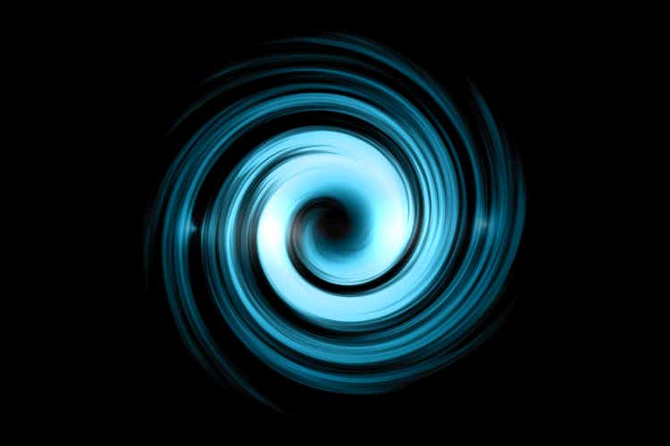 Glowing spiral tunnel with light blue cloud on black sky background
