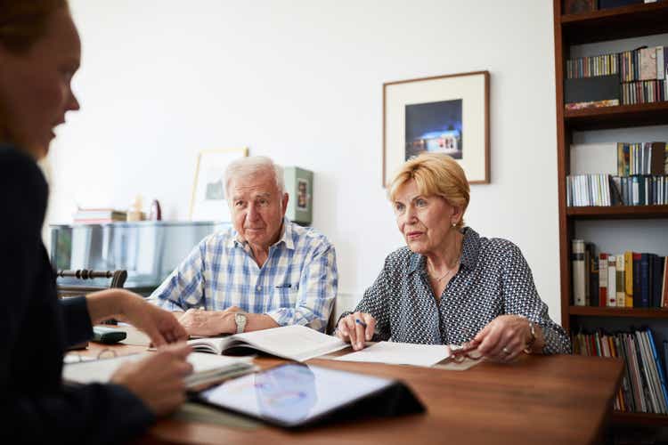 Senior couple meeting with financial consultant at home