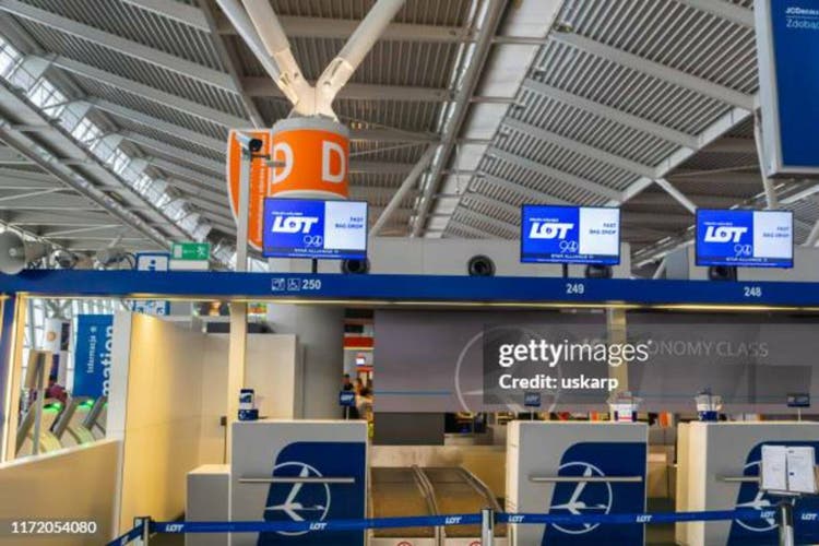 Lot Polish Airlines check-in counter area in Warsaw Chopin Airport in Poland