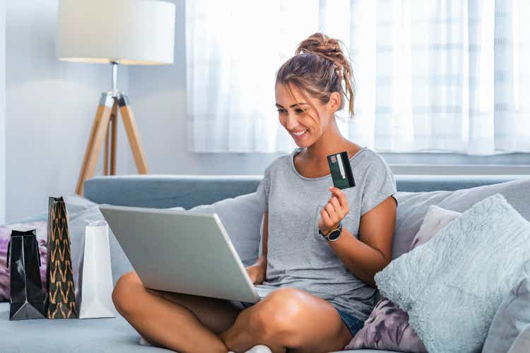 Picture showing pretty woman shopping online with credit card. woman holding credit card and using laptop. Online shopping concept