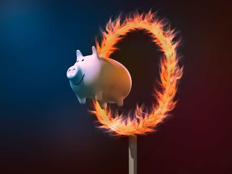 Piggy bank diving through a ring of fire