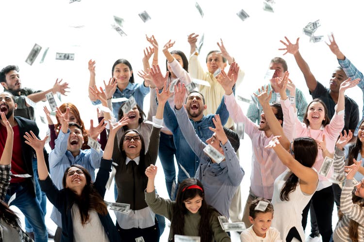 Excited group of people grabbing dollars in the air after winning the lottery