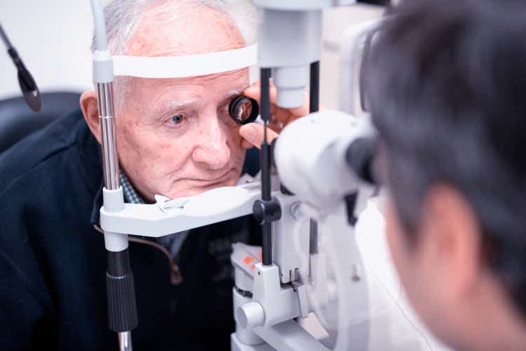 Elderly man with retinal vein occlusion visiting by the ophthalmologist before laser treatment